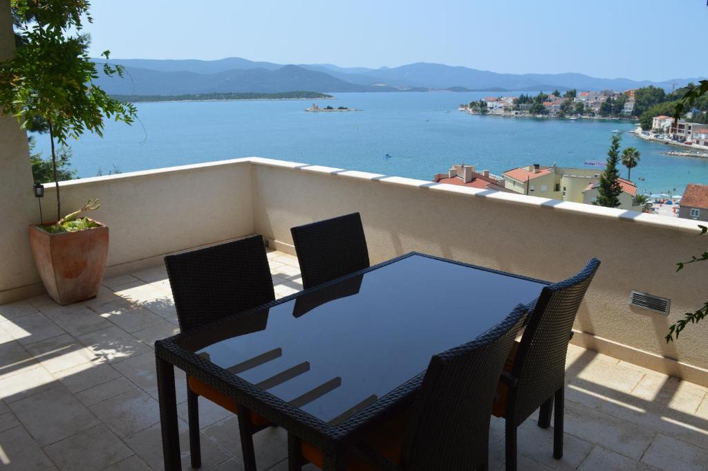 una mesa y sillas en un balcón con vistas al agua en Holiday Home Anna, en Klek