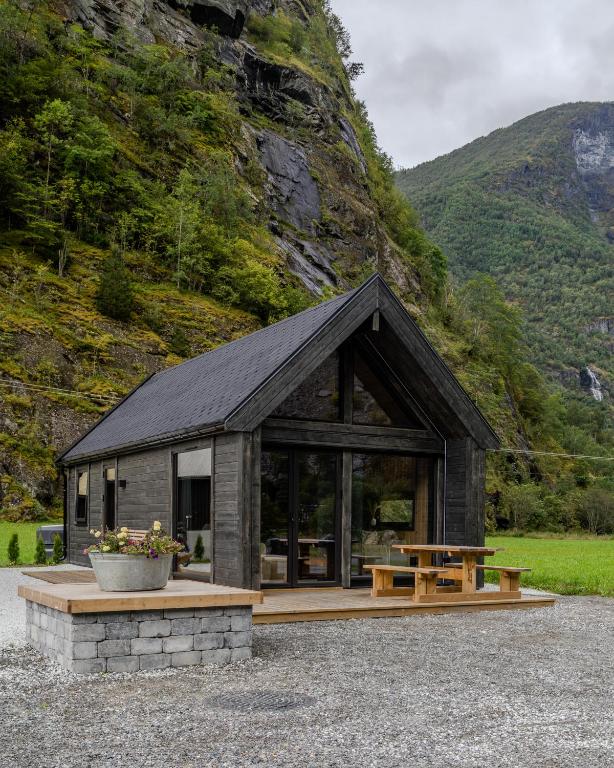 a small cabin with a bench and a table at Flåm Minisuite in Aurland