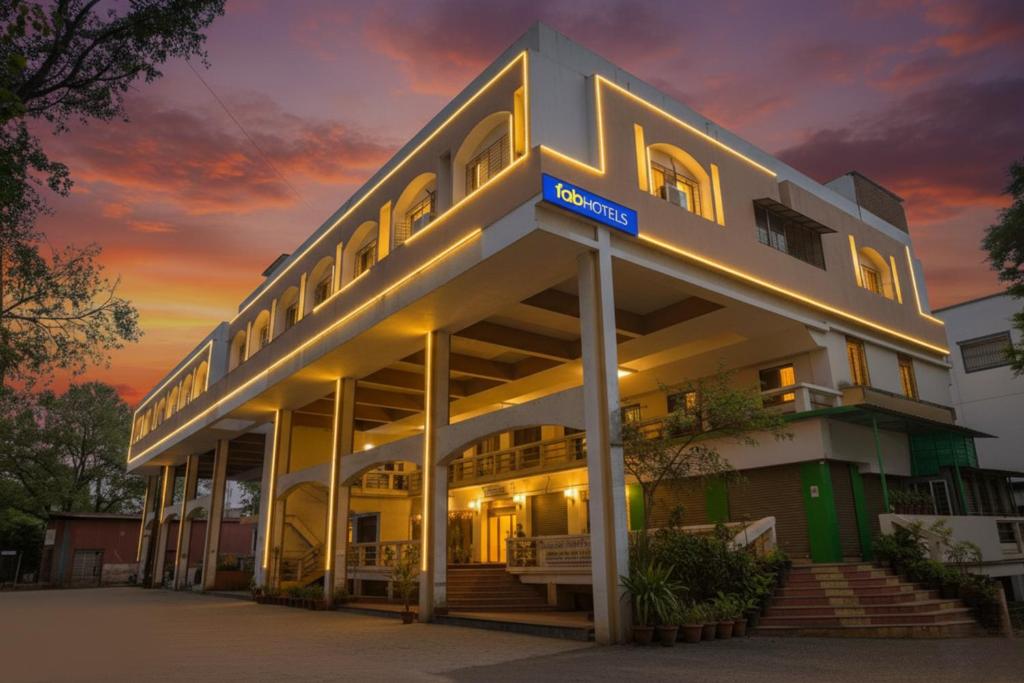 a building with a sign on the front of it at FabExpress Om Sai - Nr Nashik Railway Station in Nashik