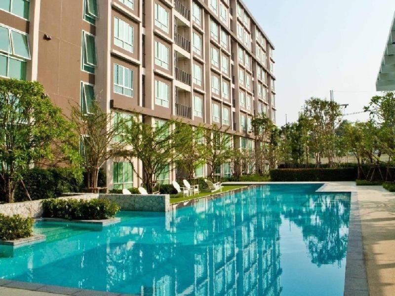 a large swimming pool in front of a building at ฺBaan Peang Ploen Hua-Hin by Montri.C in Hua Hin