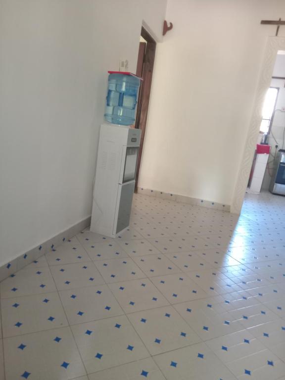 a room with a washer and dryer on a tile floor at Dannys&nickson holiday homes in Watamu