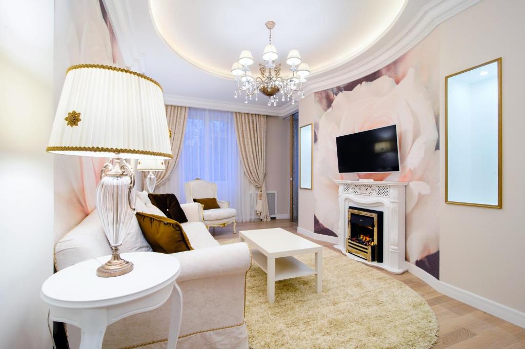 a living room with a white couch and a fireplace at Kvartira XL in Minsk