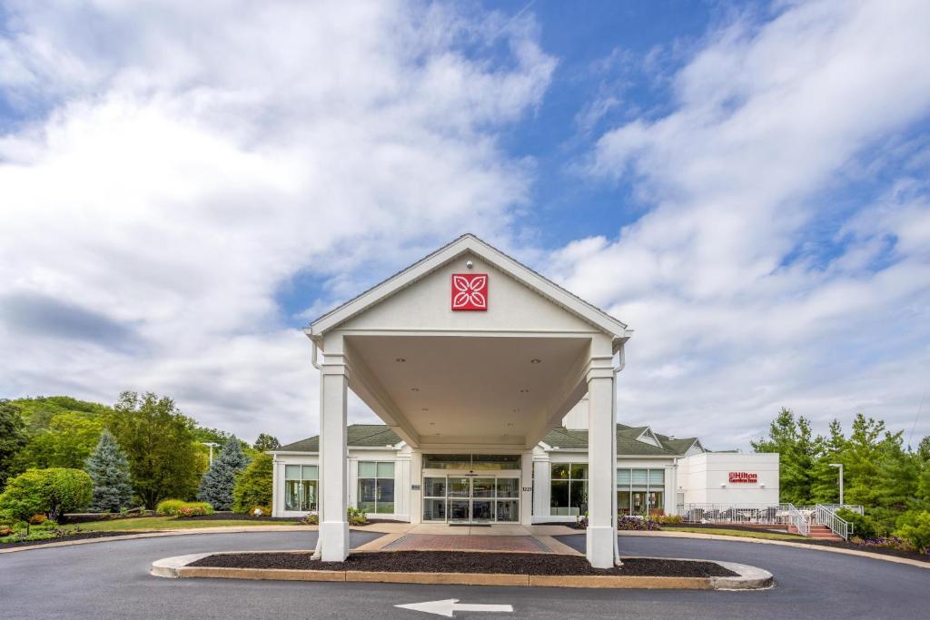 a large white building with a red x on it at Hilton Garden Inn State College in State College