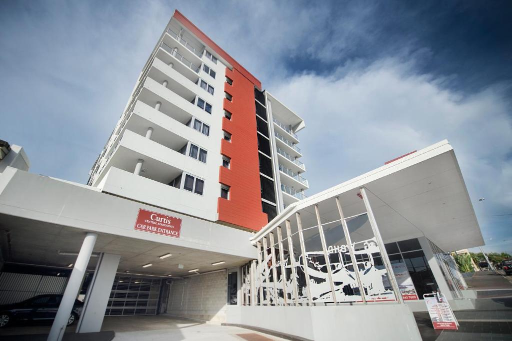 a large building with a red and white at Curtis Central Apartments in Gladstone