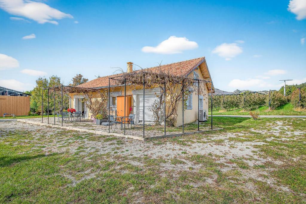 a small house with a fence around it at Gîte La Grange Des Pépinières in Saint-Auban-dʼOze