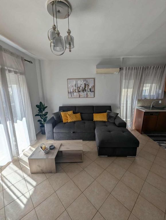 a living room with a couch and a table at Byron suite in Kavála
