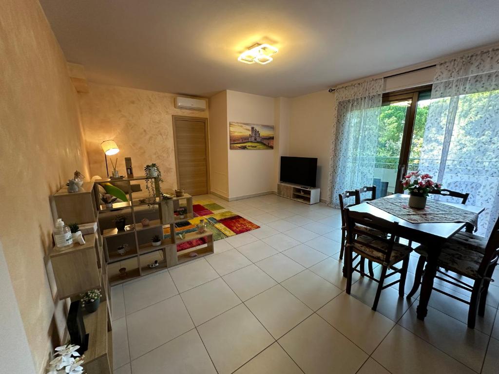 a living room with a table and a television at Il Sogno di Olly - Assisi in Santa Maria degli Angeli