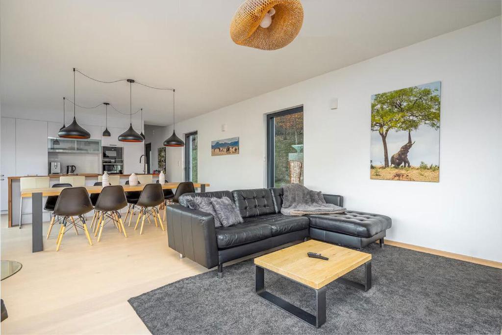 a living room with a couch and a table at Villa calme avec vue 4 à 8 personnes - salle de sport in Saint-Amarin