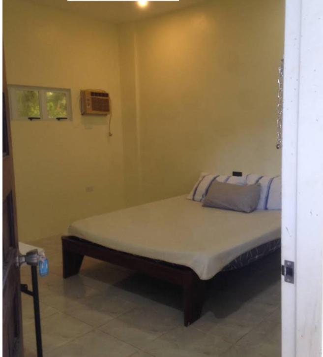 a bedroom with a bed in a room at Eufro's Place in Guiuan