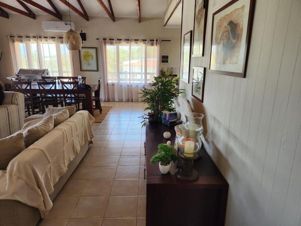a living room with couches and a table with plants at Ponta Serenity Spot in Lopes