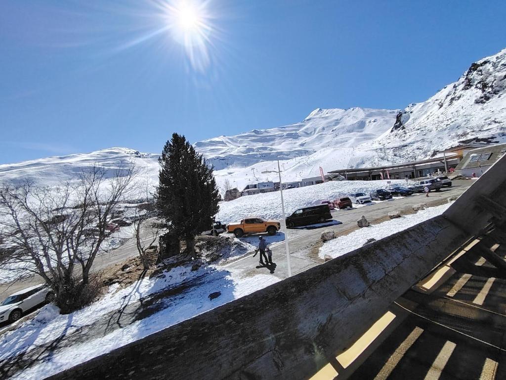 a person walking down a street in the snow at À deux pas des pistes in Aragnouet