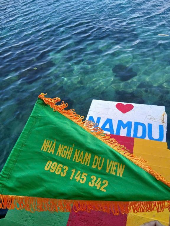a flag on the side of the water at Nam Du VIEW Guest House in Nam Du