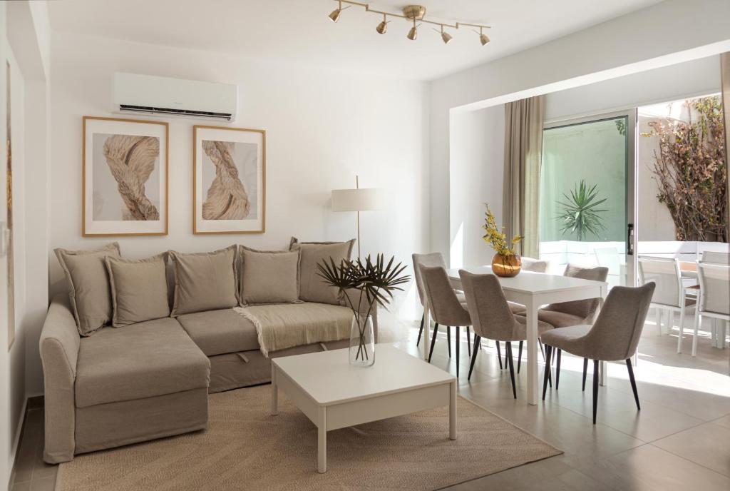a living room with a couch and a table at Sienna Townhouse by Staycom in Paphos City