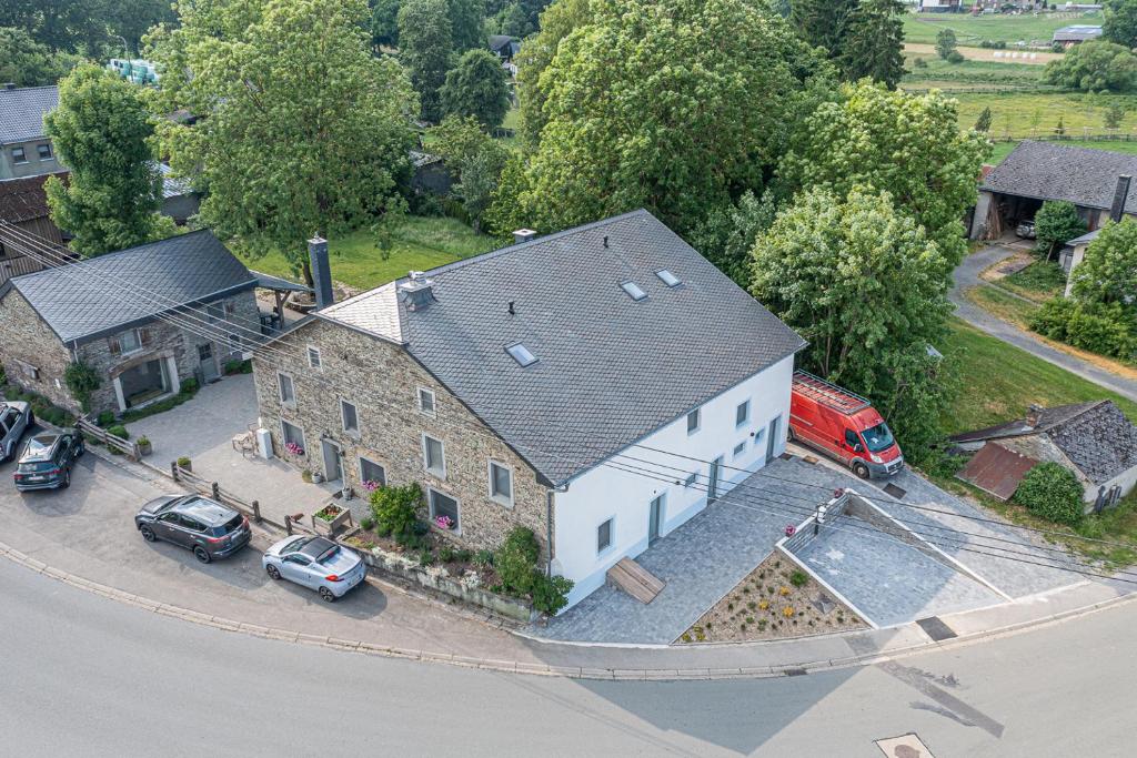 an overhead view of a house with cars parked in a driveway at B&B - La Maison des Sottais in Burg-Reuland