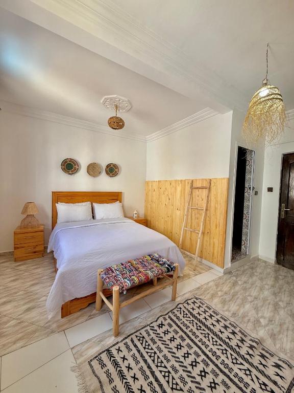 a bedroom with a large bed with a wooden headboard at Onda Surf in Taghazout