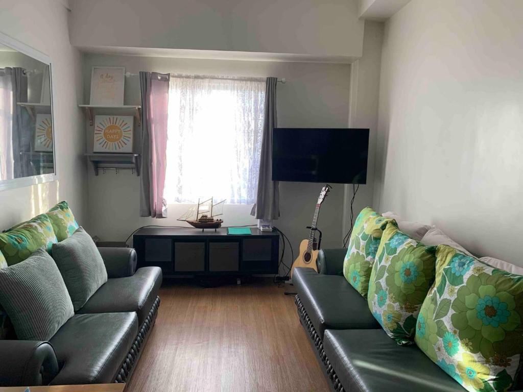 a living room with a couch and a table at The Loop Tower Downtown City Centre Comfy 2bR in Pontud