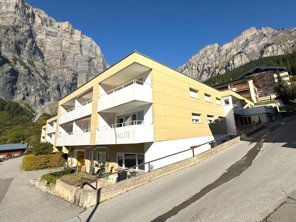 a building on the side of a road with a mountain at Salute 105 in Leukerbad
