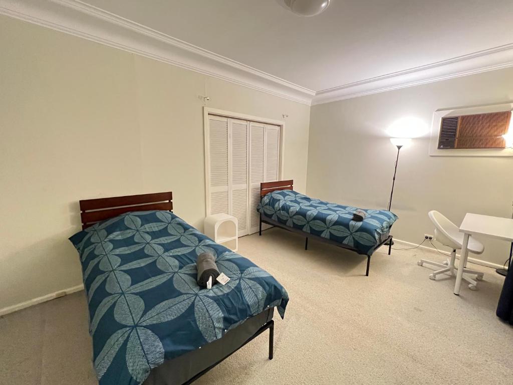 a bedroom with a dog laying on a bed at Twin Room Ideal for Friends and Travelers - R5 in Sydney