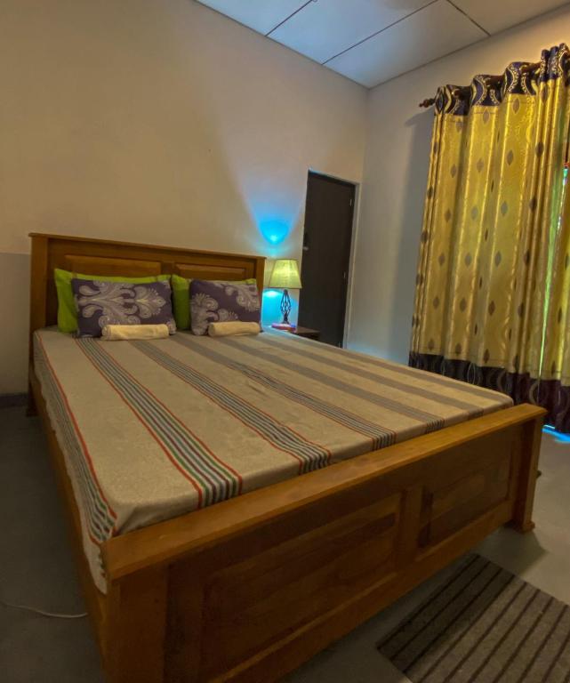 a bedroom with a large wooden bed in a room at Haven Villa in Ahangama