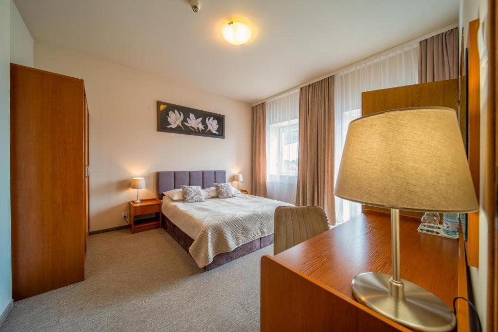 En eller flere senge i et værelse på NOVA Centrum Hotel