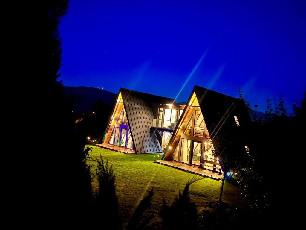 a house that is lit up at night at Zago Alpin in Câmpulung Moldovenesc