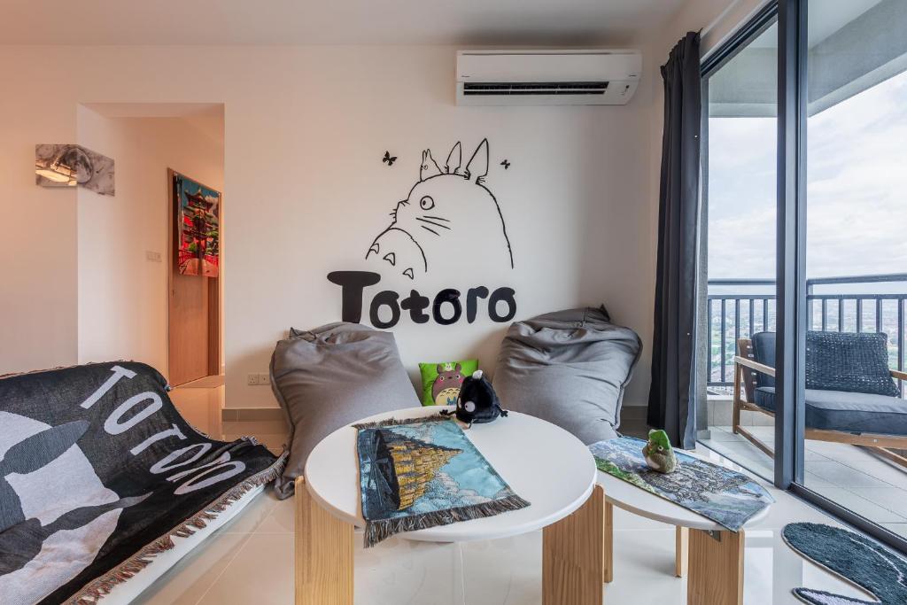 a living room with a table and chairs at Aradia Lakecity with Totoro Muji Theme in Batu Caves Selayang, Kuala Lumpur by Nestaway in Kuala Lumpur
