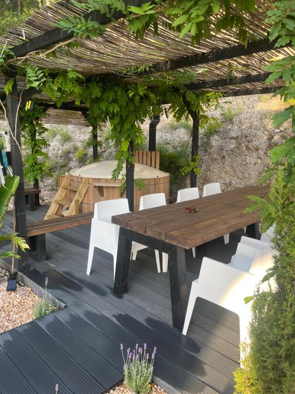 a wooden table and chairs under a pergola at Casa Luna in La Drova