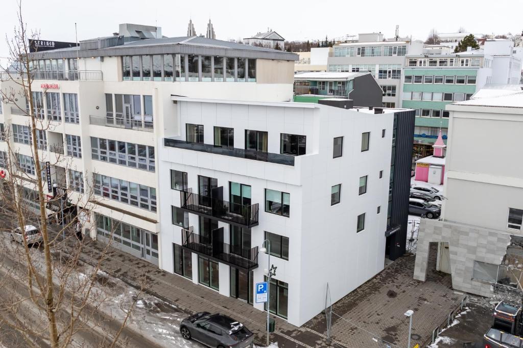 an aerial view of a white building in a city at LL Properties - Stylish Apartment in Akureyri in Akureyri