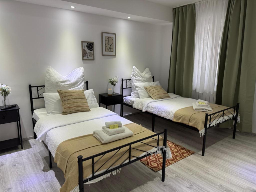 a room with two beds and a table at M B Homes Lauterstein 8 in Weißenstein