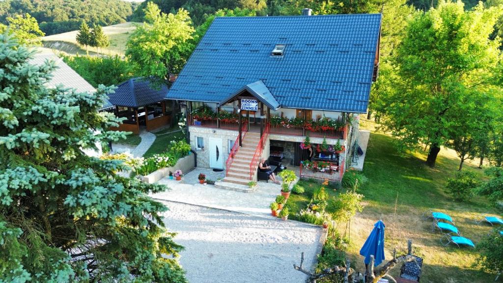 an overhead view of a house with a blue roof at Guest House Family Varda Plitvice Lakes in Plitvička Jezera