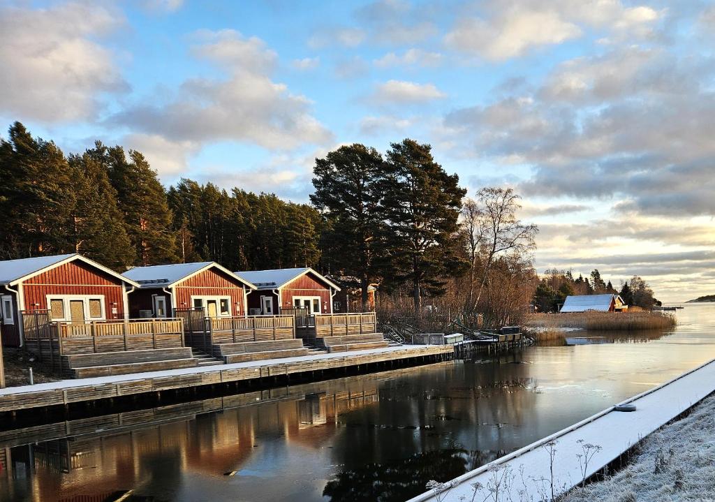 a row of houses next to a river at Färjas Brygga in Söråker