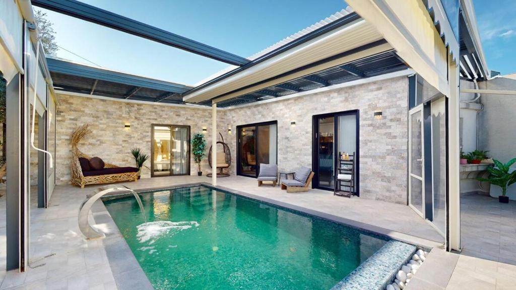 a swimming pool in a house with a patio at זוהר בגליל-מיני וילה עם בריכה וג'קוזי בעין יעקב in ‘Ein Ya‘aqov