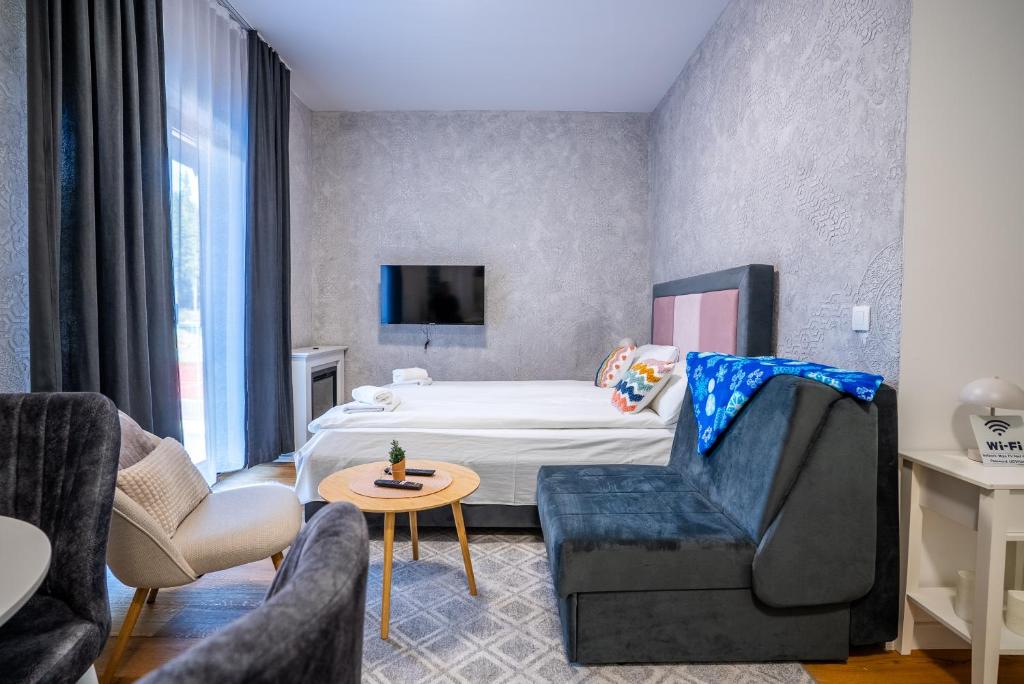 a hotel room with a bed and a chair at Mountain goat Bjelašnica in Bjelašnica