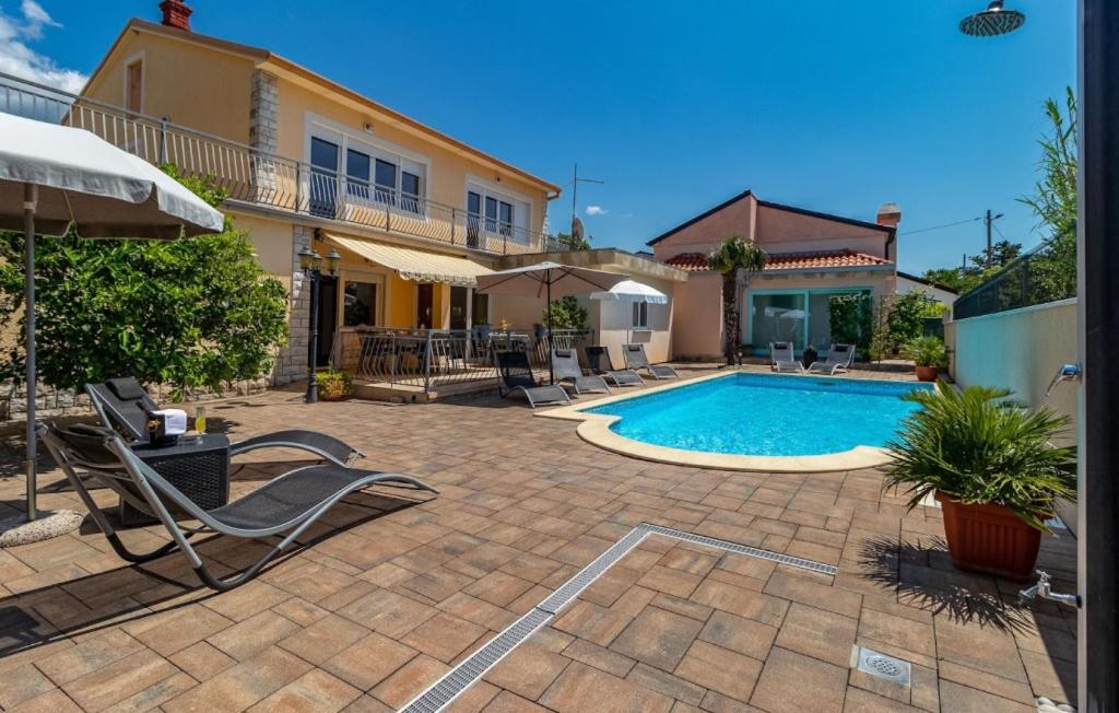 a backyard with a swimming pool and a house at Villa Mary by Villas Guide in Jadranovo