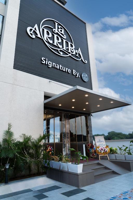 Hotel La Arriba, a sign on the side of a building at Hotel La Arriba in Ahmedabad