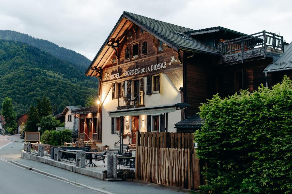 a large wooden building on the side of a street at Auberge des Gorges - Restaurant Gastronomique & Chambres in Servoz