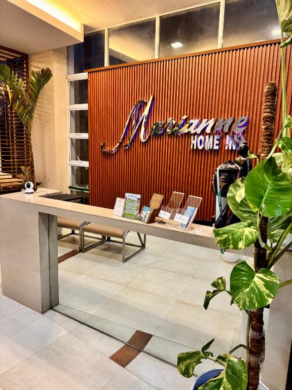 a store with a bench with a sign on it at Marianne Home Inn - PPC in Puerto Princesa City