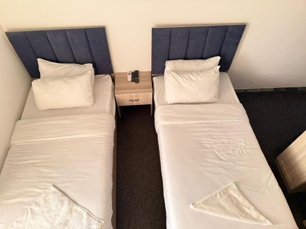 two twin beds in a room with a desk at ملك دجلة - Malik Dijla in Baghdad