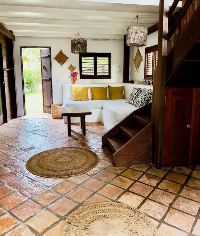 a living room with a white couch and a table at Casa do Boi, charming house ideally located in Atins ! in Atins