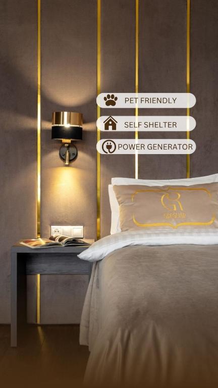 a bedroom with a bed and a table with a lamp at Greguar Hotel by UHM in Kyiv