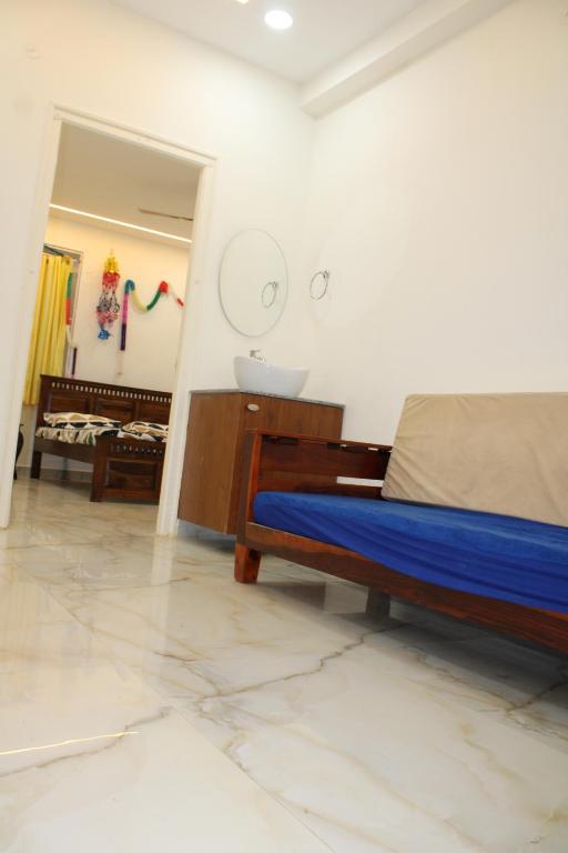 a bedroom with a bed and a sink in it at svhotel in Tirupati