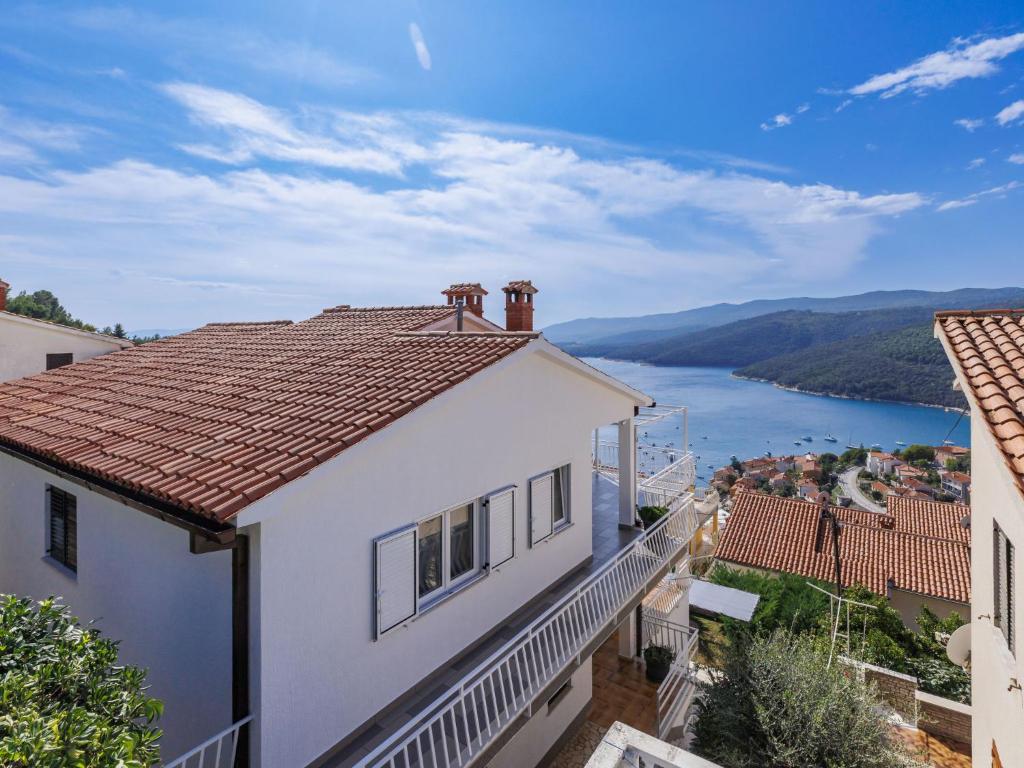 a white house with a view of a river at Apartment Katarina-1 by Interhome in Rabac