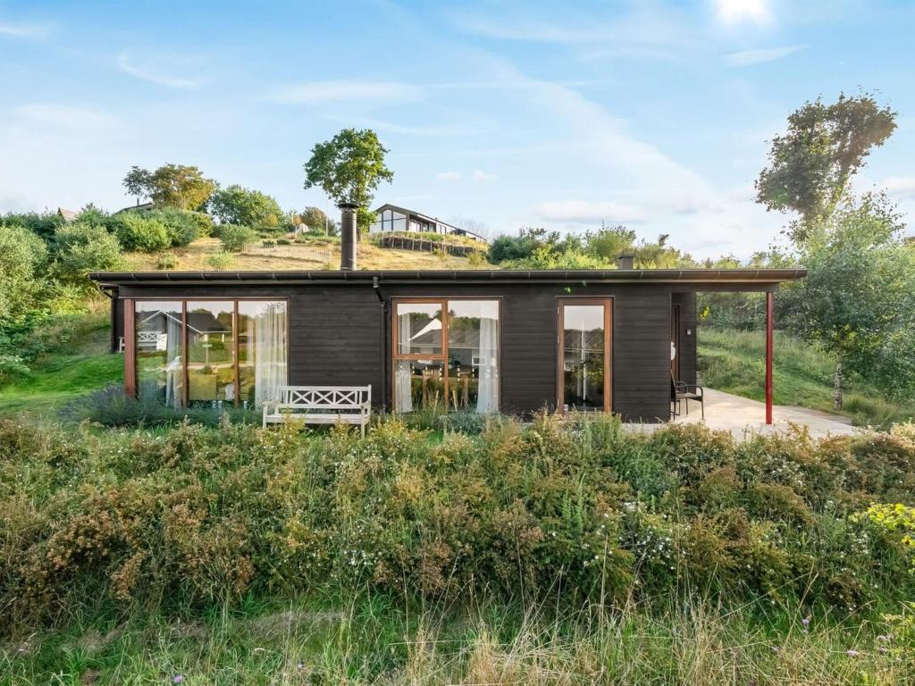 a small house with a grass roof at Holiday Home Eila - 400m from the sea by Interhome in Glesborg