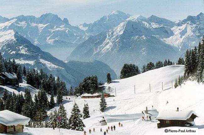 a group of people standing on a snow covered mountain at Chalet La Marmotte 1800m in Ollon
