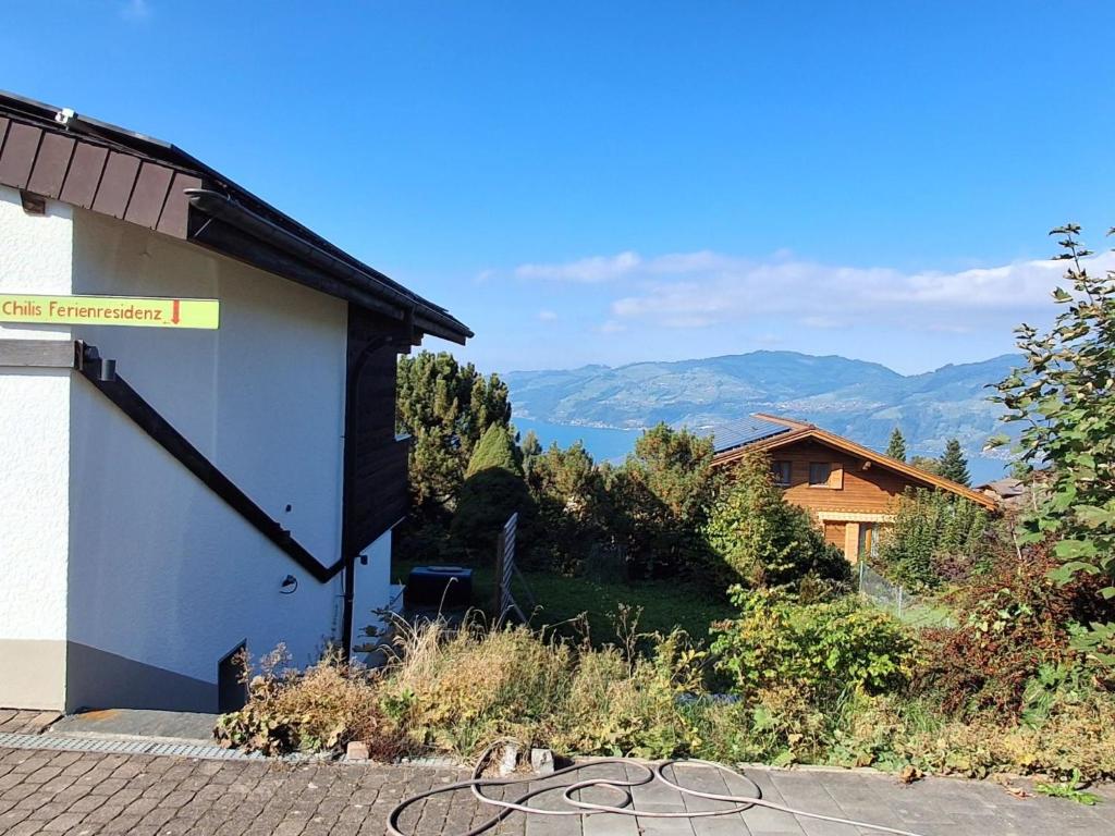 a building with a view of a lake and mountains at Apartment Chilis Ferienresidenz by Interhome in Aeschi