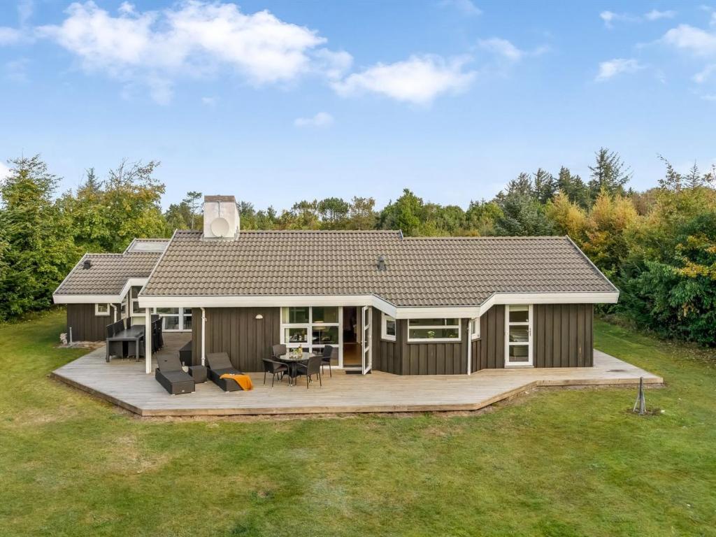 a home with a large deck and a house at Holiday Home Mechthild - 2-7km from the sea by Interhome in Saltum