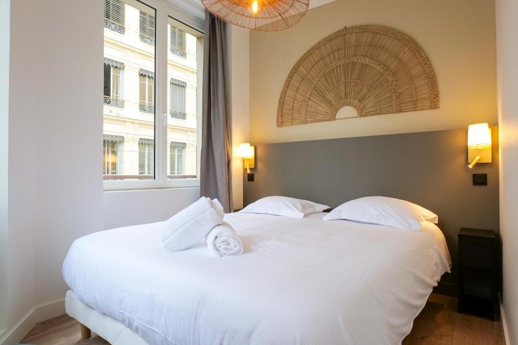 a bedroom with two white beds and two windows at Le Chenavard I-hyper centre-Central air conditioning in Lyon