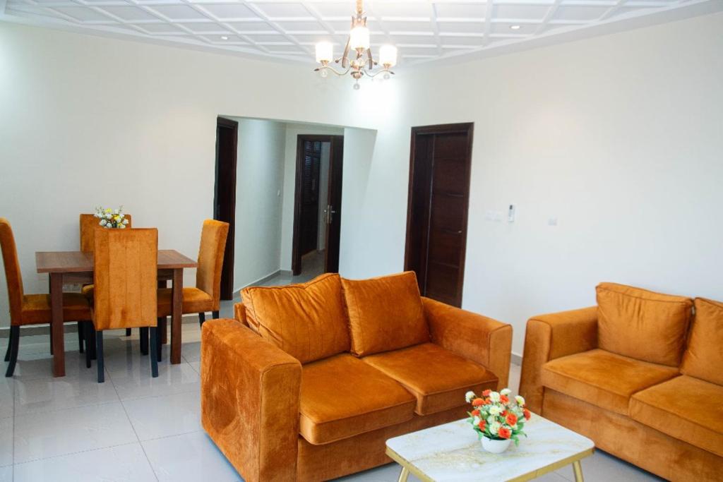a living room with two couches and a table at Yaoundé in Yaoundé