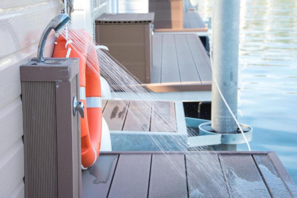 a boat with an orange life preserver next to a pool at Luxury Floating Sea House Star Line - Marina Portorož in Portorož