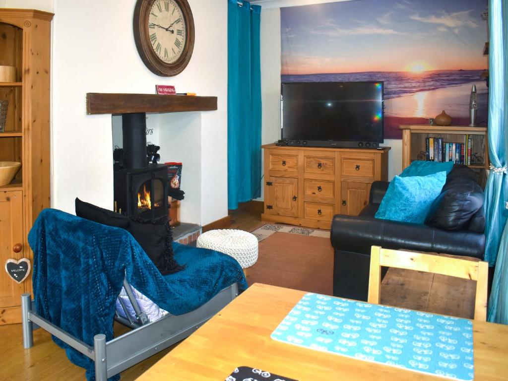 a living room with a couch and a fireplace at Mariners Cottage in Dawlish
